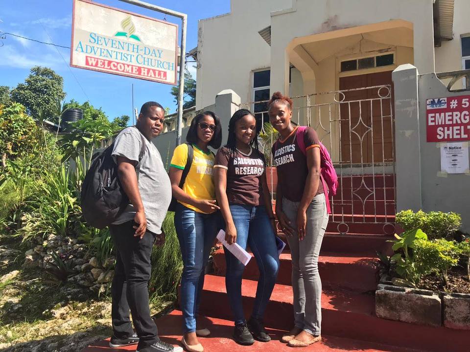 Four Balcostics Research interviewers on the steps outside a Seventh-day Adventist church